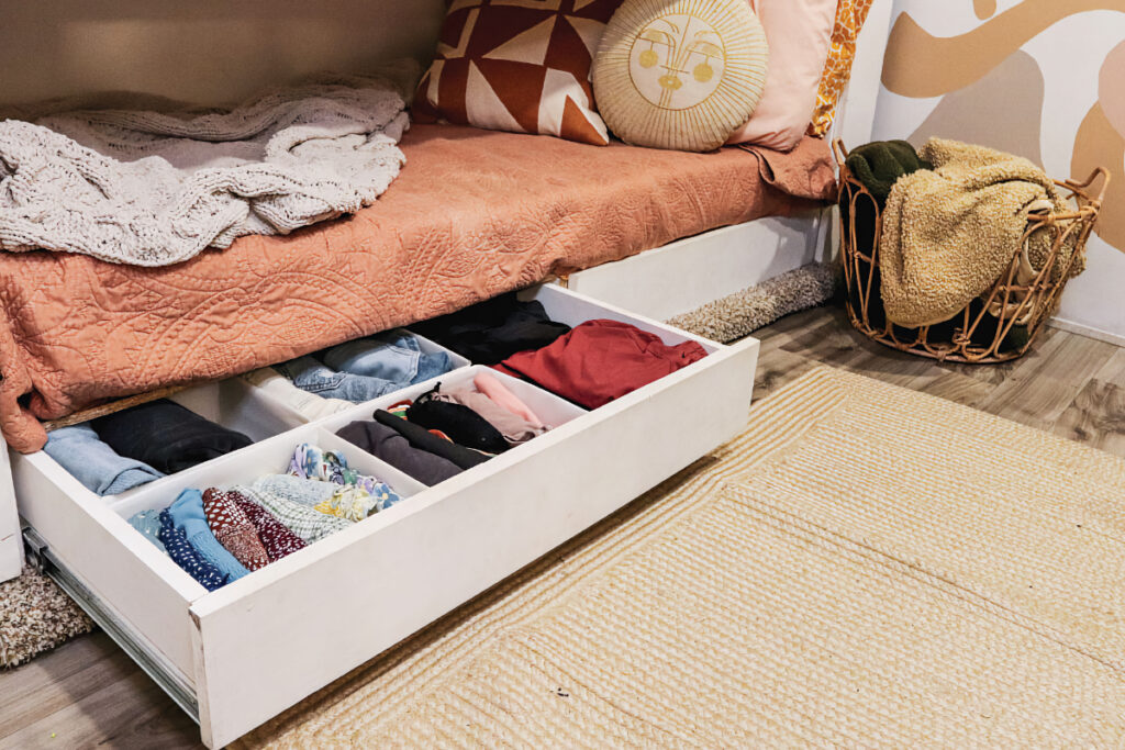 A drawer pulled out from under bed storage in an RV